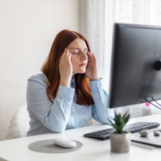 Young Caucasian women are stressed and tired from work at a white desk with a computer in the office